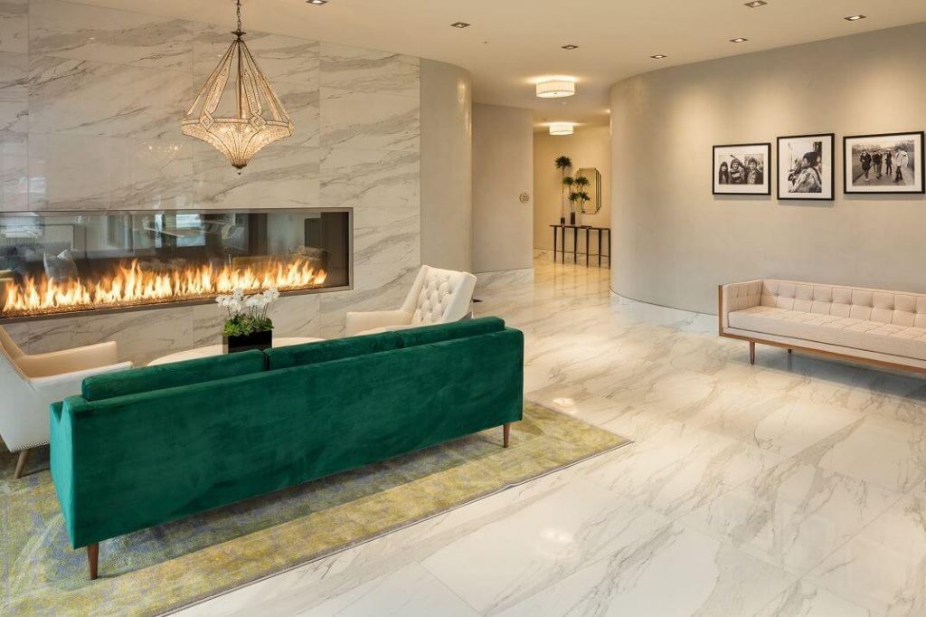 Acucraft Blaze 10 Tall See Through Gas Fireplace with Glass Media and a Green Sofa