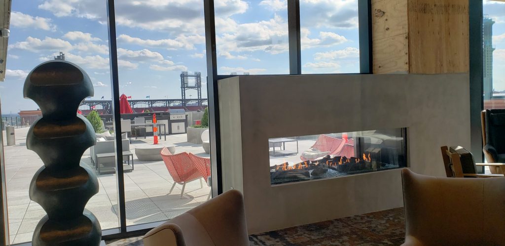 Acucraft Custom Linear Indoor Outdoor Gas Fireplace with Starfire Glass Media & Driftwood