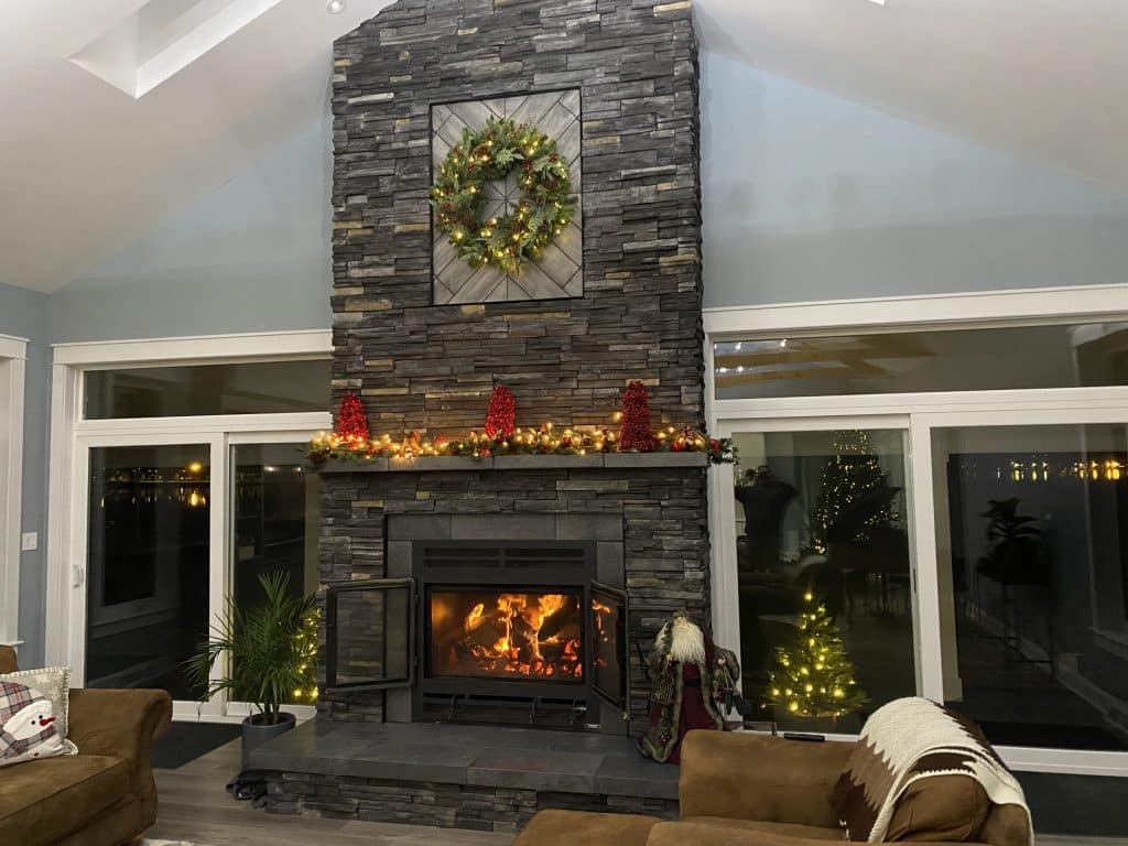 A wood-burning fireplace with a natural stone surround in a rustic yet elegant setting.