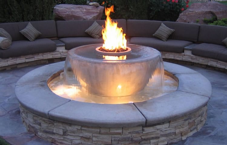 Acucraft Custom Outdoor Burner on Fountain Acucraft custom outdoor burner seamlessly integrated into a fountain, showcasing endless customization options for adding a unique and luxurious fireplace to any patio.