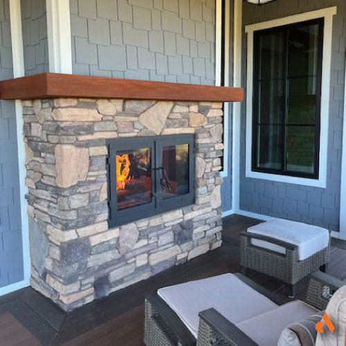 modern double sided inside outside wood burning fireplace in new construction home